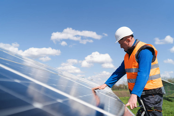 Ingeniero de planta de energía solar hace una inspección visual de paneles solares - Foto, imagen