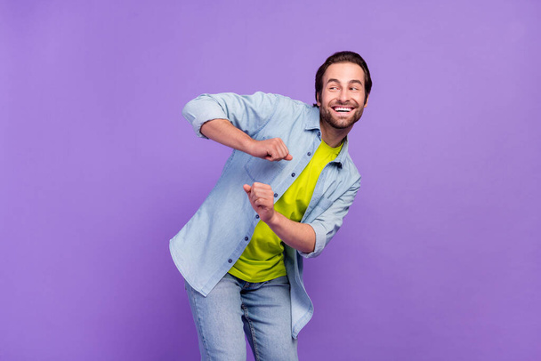 Photo of funky carefree male look copyspace dancing having fun laughing isolated on violet color background - Fotografie, Obrázek