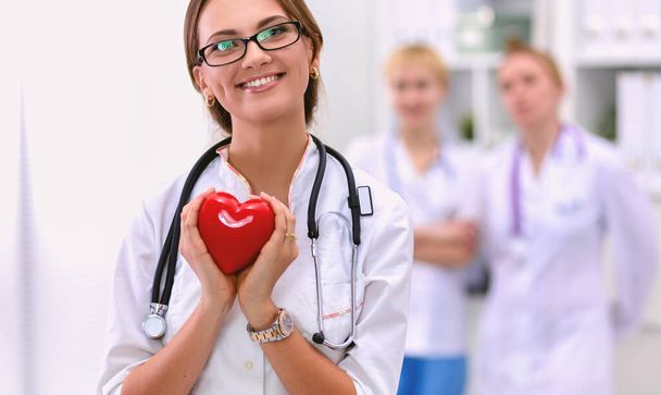 Doctor with stethoscope holding heart, isolated on white background - Φωτογραφία, εικόνα