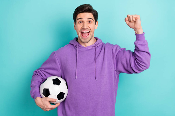 Photo of funky ecstatic screaming guy football fan raise fist in victory hooray goal isolated on blue color background - Photo, Image