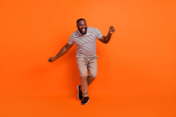 Full size photo of youth excited african guy have fun dancer event clubber isolated over orange color background - Фото, изображение