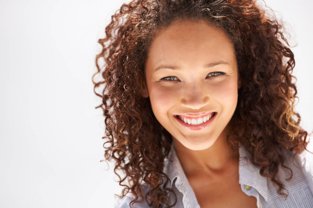 Fresh-faced and naturally beautiful. Cropped view of a naturally gorgeous young woman smiling at you. - 写真・画像