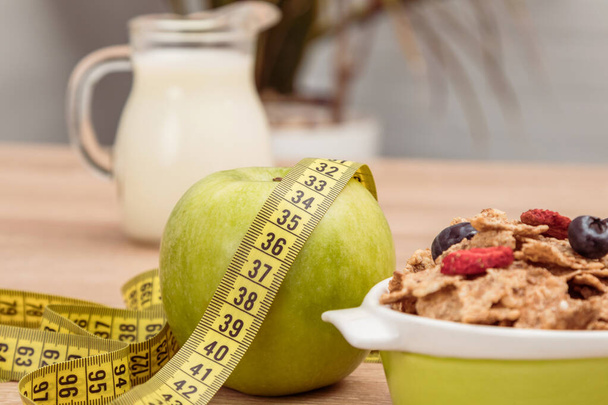 balanced breakfast, fruit and cereals with measuring tape - Photo, image