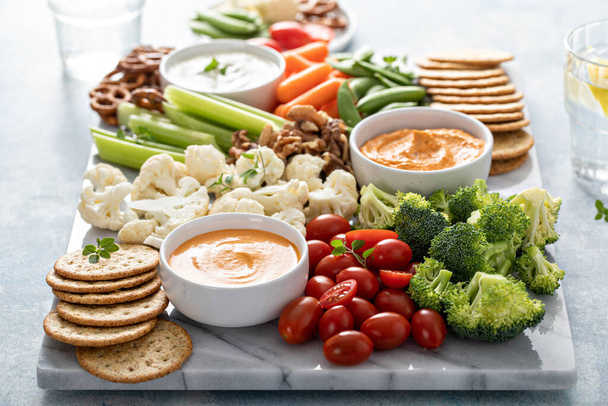 Plant based snack board with vegetables and crackers - Φωτογραφία, εικόνα