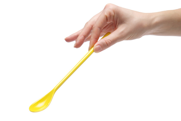 Hand holding an empty teaspoon - Foto, imagen