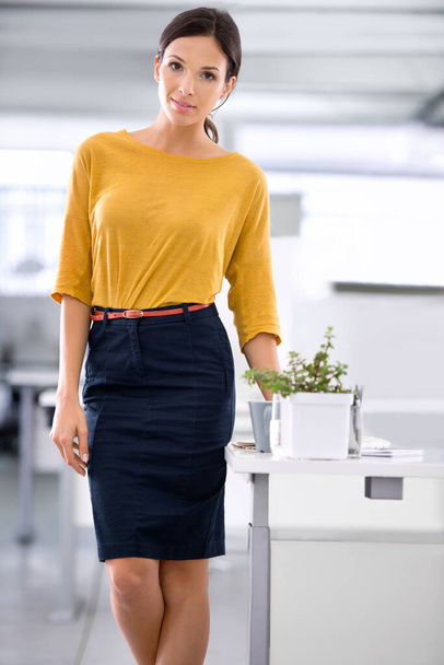 Priding herself on her professionalism. A beautiful young businesswoman standing alongside her desk in the office. - Photo, Image