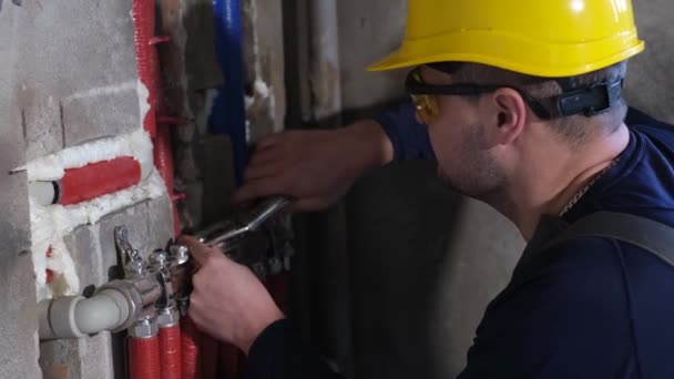 A plumber installs heating in a new house.  - Footage, Video