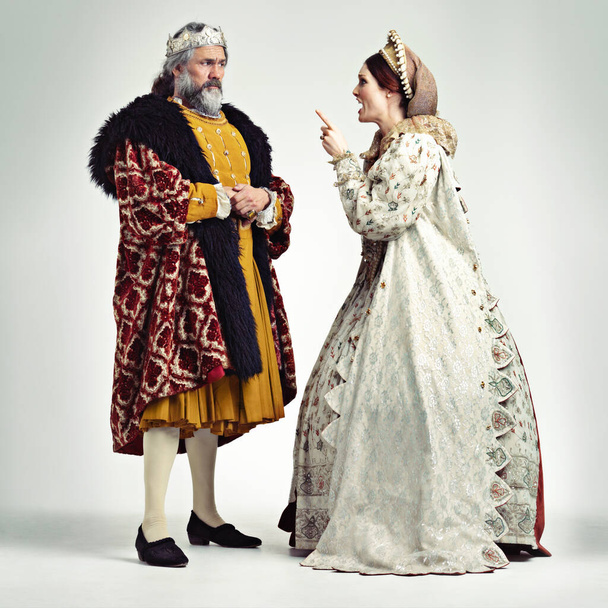 I dont care who you are. Studio shot of a king and queen arguing. - Foto, imagen