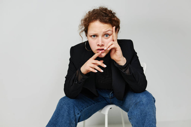 beautiful woman sitting on a chair in a black jacket fashion posing Lifestyle unaltered - Fotografie, Obrázek