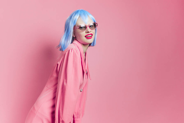glamorous woman in blue wig pink dress red lips isolated background - Foto, immagini