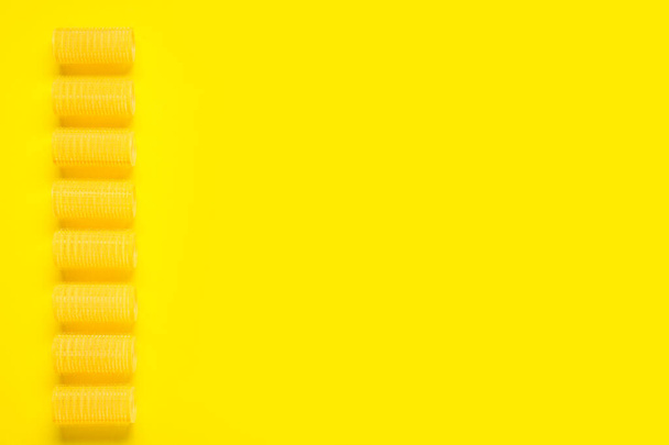 Set of hair curlers on yellow background - Valokuva, kuva