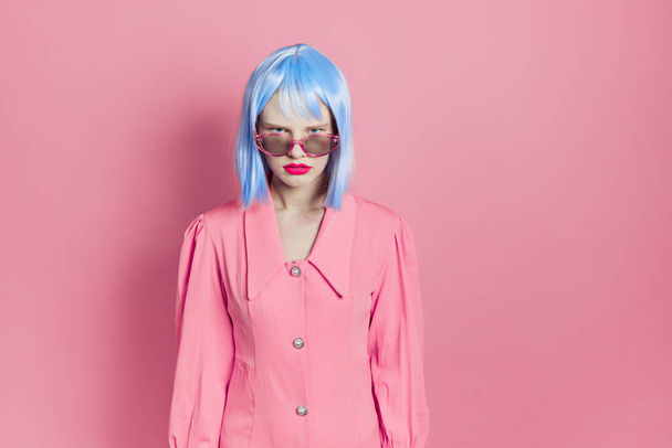 fashionable woman in blue wig pink dress red lips studio model - Photo, Image