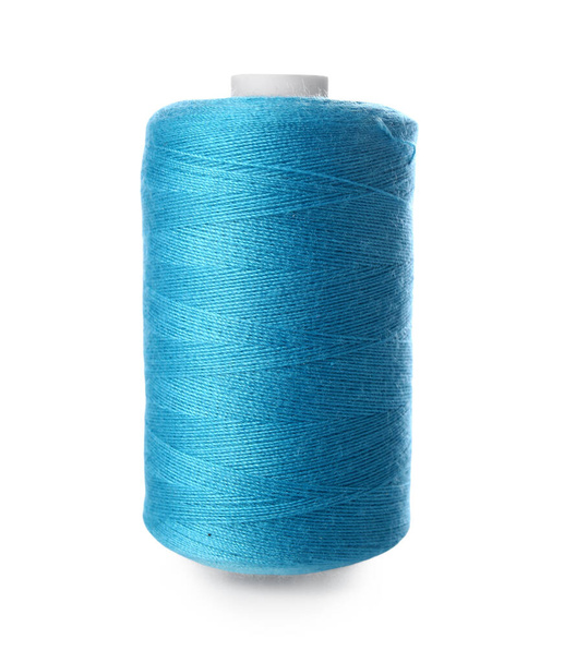 Blue sewing thread spool on white background - Фото, изображение