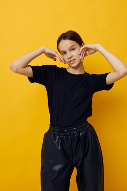 optimistic young woman in a black T-shirt and pants smile isolated background - Фото, зображення