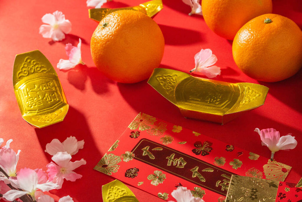 Flat lay mockup for holiday Chinese new year red packet and gold accessories blossom and Lunar festival background, means wealthy or rich and happiness - Photo, Image