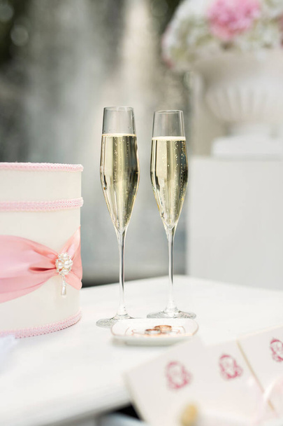 Wedding glasses with champagne on the table. - 写真・画像