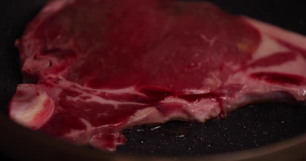 Grilling T born stake meat on the pan in the kitchen close up - Footage, Video