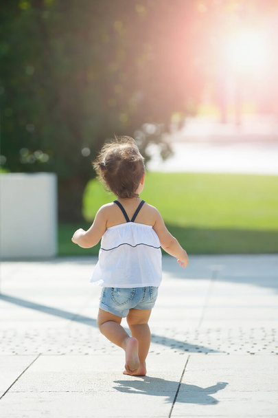 Retrato de un niño de una niña en un parque en verano en tiempo soleado. Una joven modelo. - Foto, Imagen