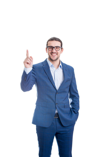 Confident businessman pointing up forefinger smiling isolated on white background. Contented business person, wearing eyeglasses, determined shows index finger upwards - Φωτογραφία, εικόνα