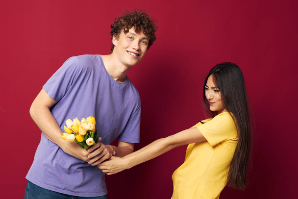 cute young couple a bouquet of yellow flowers based friendship isolated background unaltered - Фото, изображение