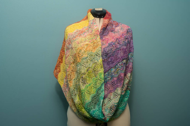 knitted handmade shawl on a white mannequin - multicolored yarn. - Photo, Image