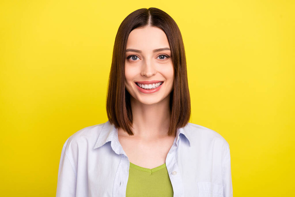 Photo of cute brunette millennial lady smiling wear blue shirt isolated on yellow color background - Foto, Bild