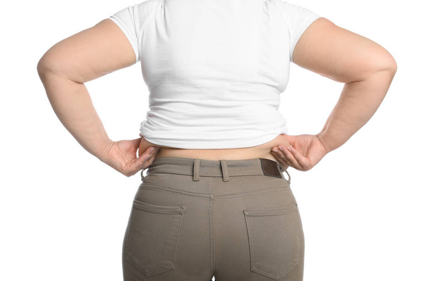Overweight woman in tight t-shirt and trousers on white background, closeup. Back view - Фото, изображение