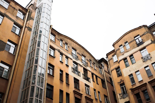 old buildings in a big European city are hung with wires and modern details - 写真・画像