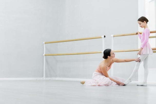 side view of ballet master teaching girl in dance school - Photo, Image