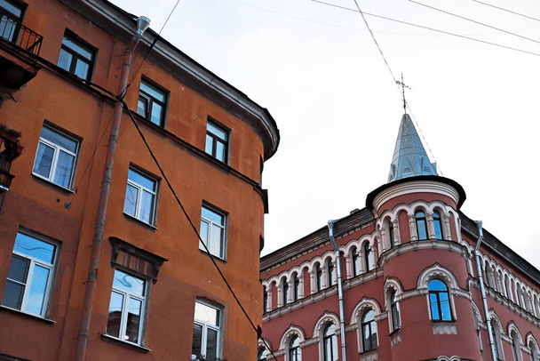 old buildings in a big European city are hung with wires and modern details - Fotó, kép