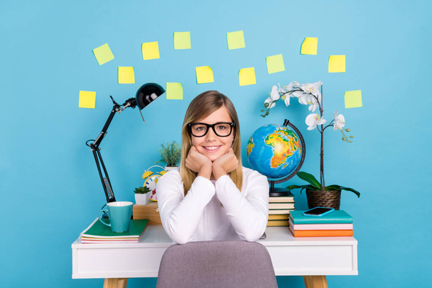 Portrait of attractive brainy cheery cute girl doing home work task self isolation isolated over bright blue color background - Foto, afbeelding