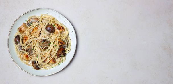 Pasta spaghetti in a creamy sauce with chicken and mushrooms. Italian food - Fotó, kép