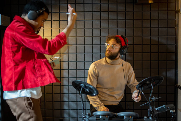 Чоловіки грають на електричних барабанах вдома студії
 - Фото, зображення