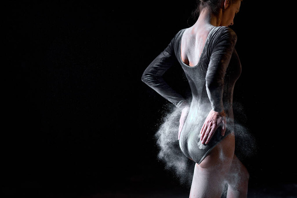 Rear view on ballet dancer woman shaking off the flour after dance perfromance - Foto, imagen