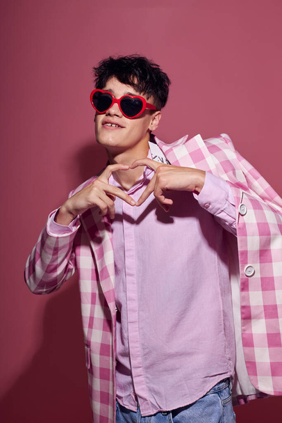 handsome guy self confidence pink plaid blazer fashion posing pink background unaltered - Foto, afbeelding