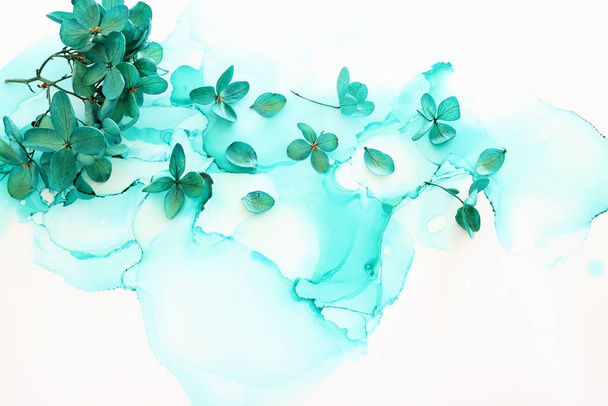 Creative image of emerald and green Hydrangea flowers on artistic ink background. Top view with copy space - Φωτογραφία, εικόνα