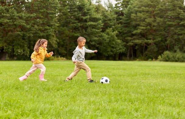 little children with ball playing soccer at park - Foto, Imagem