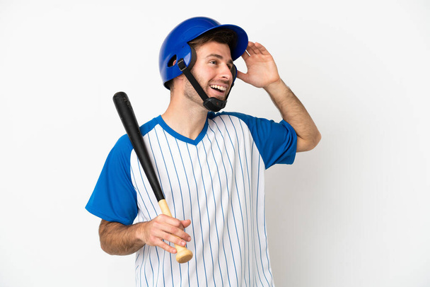 Young caucasian man playing baseball isolated on white background smiling a lot - Fotoğraf, Görsel