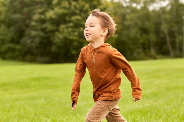 happy little boy running at park - Fotoğraf, Görsel