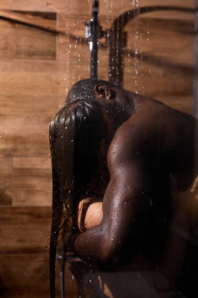 Sexy beautiful mixed race couple in shower.Kissing hugging couple portrait - Фото, изображение
