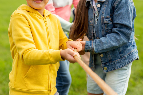 close up of children playing tug-of-war game - Photo, image