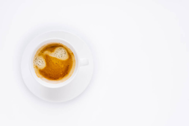 a white cup of coffee with a beautiful foam and a white saucer on a white background. isolate. copy space. High quality photo - 写真・画像
