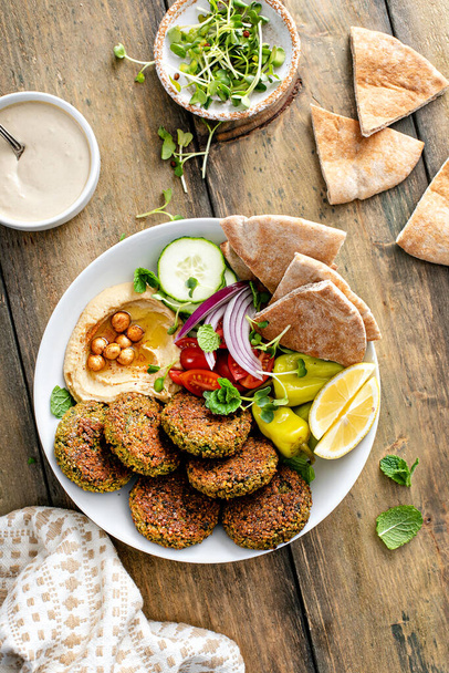 Baked falafel bowl with hummus and vegetables - Photo, image