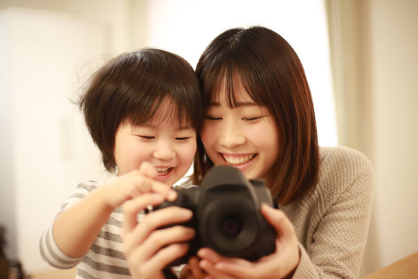 portrait of young asian woman and boy  camera  - Фото, изображение