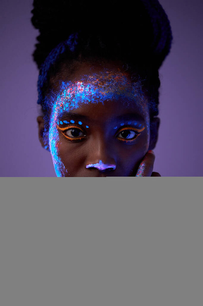 sensual photo of young stunning black woman with flurescent make-up on body - 写真・画像