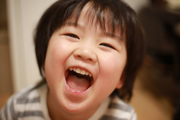 portrait of a cute little child laughing at home - Photo, Image