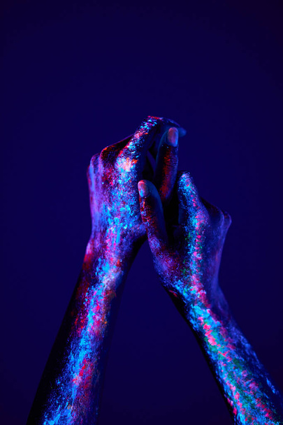 cropped hands with fluorescent art isolated on dark background, minimal fashion - Photo, Image
