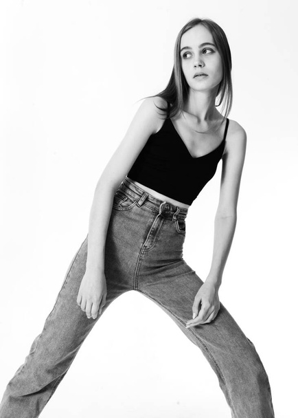 black and white photo of a girl in fashionable jeans - Фото, зображення