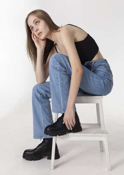 beautiful blonde posing in light jeans and black top - Zdjęcie, obraz