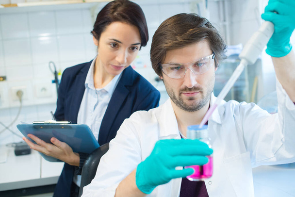 young chemical male researcher working with manager - 写真・画像